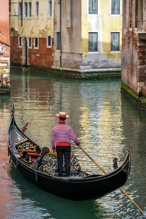 Framed Print : Gondolier with hat on gondola boat in a water canal, Venice, Veneto, Italy Framed Print : Gondolier with hat on gondola boat in a water canal, Venice, Veneto, Italy