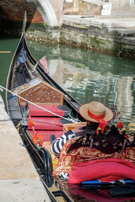 Framed Print : Gondolier resting on a moored gondola boat, Venice, Veneto, Italy Framed Print : Gondolier resting on a moored gondola boat, Venice, Veneto, Italy