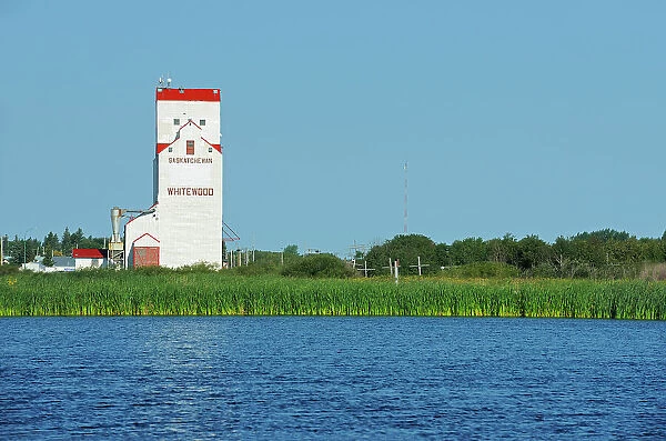 Grain elevator reflected in a wetland Whitewood Saskatchewan, Canada