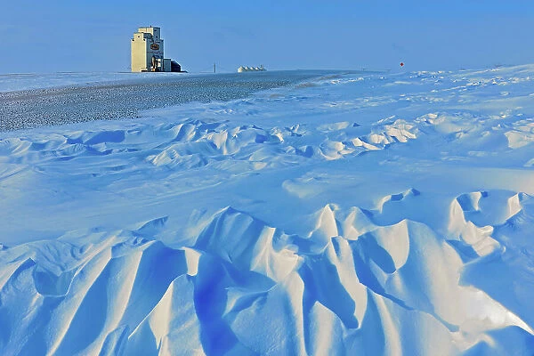 Grain elevator and wind sculptured snow WIllows Saskatchewan, Canada