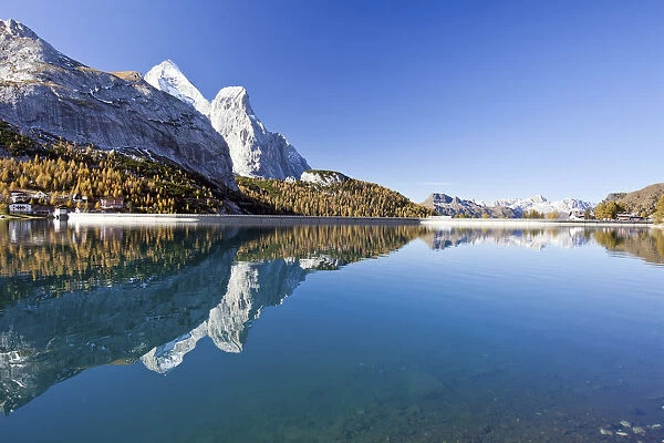The Gran Vernel reflected in Lake Fedaia in an autumn morning