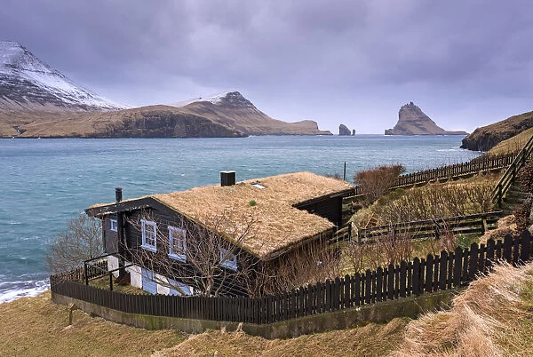 Grass roofed house in the village of Bour on the island of Vagar, Faroe Islands, Denmark, Europe. Spring (April) 2015
