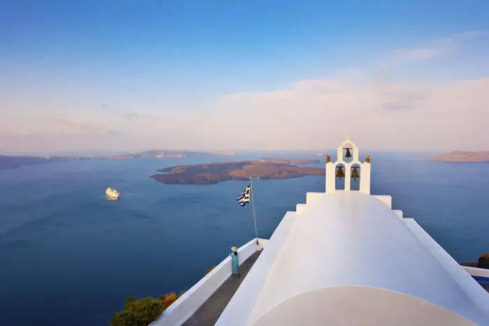 Framed Print : Greece, The Cyclades, Santorini (Thira), Imerovigli, Woman standing infront of white Framed Print : Greece, The Cyclades, Santorini (Thira), Imerovigli, Woman standing infront of white