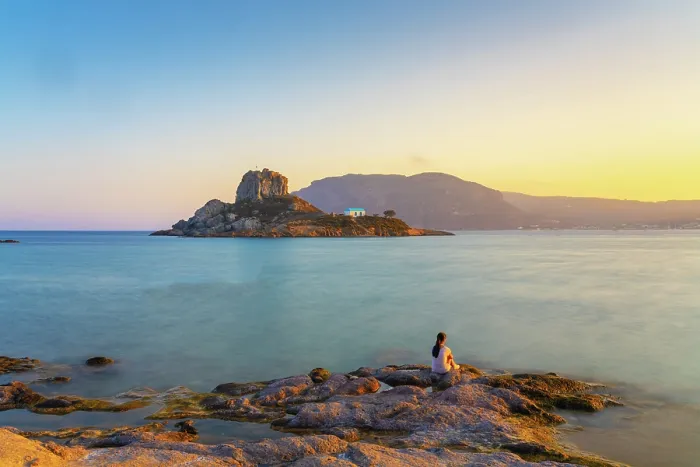 Framed Print : Greece, Dodecanese, Kos Island, Kamari Bay, Girl at Agios Stefanos Beach, and Kastri Island (MR) Framed Print : Greece, Dodecanese, Kos Island, Kamari Bay, Girl at Agios Stefanos Beach, and Kastri Island (MR)