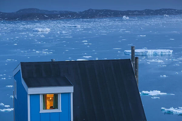 Greenland, Qaqortoq, elevated town view with floating ice, dusk