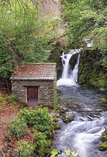 The Grot, or grotto, built in 1668 by Sir Daniel Fleming, Britain earliest known purpose built viewing station, with Rydal Fall in the background, Rydal Hall, Lake District National Park, Cumbria, England