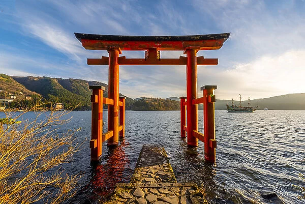 Hakone, Kanagawa Prefecture, Honshu, Japan. Red torii gate at lake Ashi