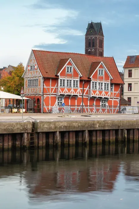 Framed Print : Half-timbered building called Gewolbe (The Vault) and tower of St. Marienkirche church in background, Wismar, UNESCO, Nordwestmecklenburg, Mecklenburg-Western Pomerania, Germany