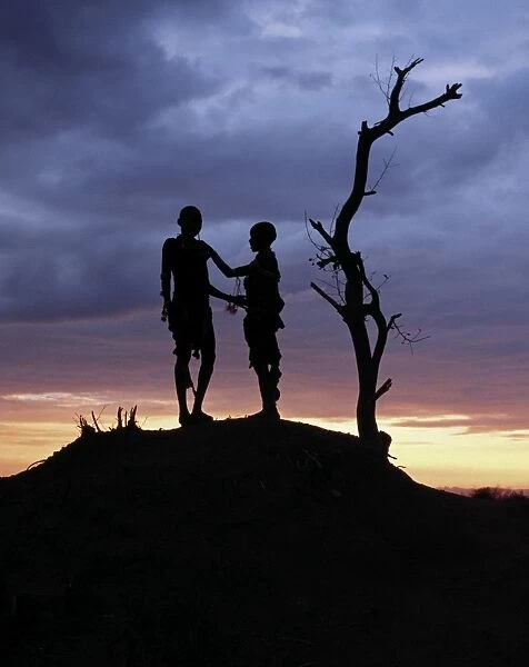 Two Hamar children silhouetted by the setting sun