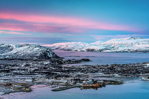High angle view of the fishing village and harbor of Brensholmen covered with snow at dawn, Sommaroy, Troms county, Norway