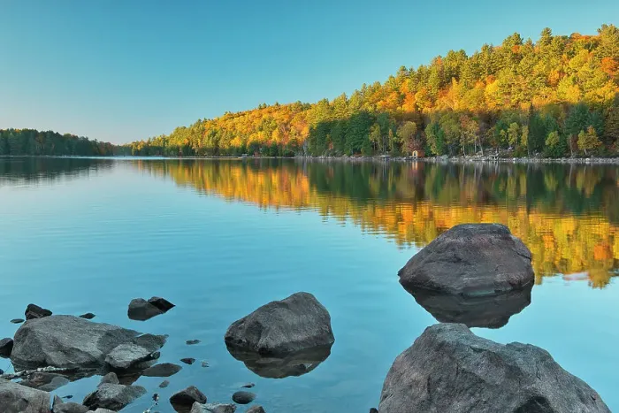 Framed Print : Hiilside of autumn colored trees reflected in Lake St. Nora Near Pine Springs, Ontario, Canada