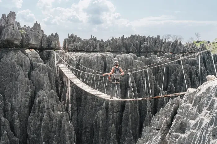 Framed Print : Hiker crosses a rope bridge. Madagascar, Africa. Tsingy De Bemaraha Framed Print : Hiker crosses a rope bridge. Madagascar, Africa. Tsingy De Bemaraha