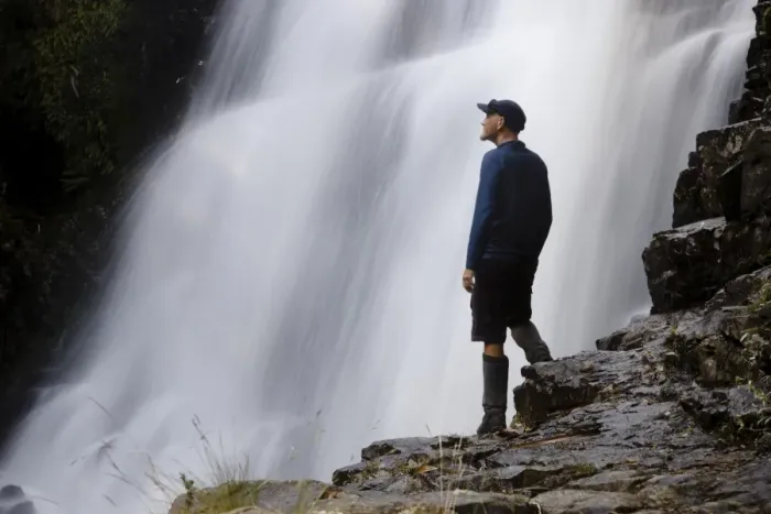 Framed Print : A hiker enjoys Fergusson Falls on the Overland Track