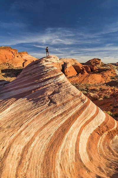 Hiker on Fire Wave, Valley of Fire State Park, Nevada, USA