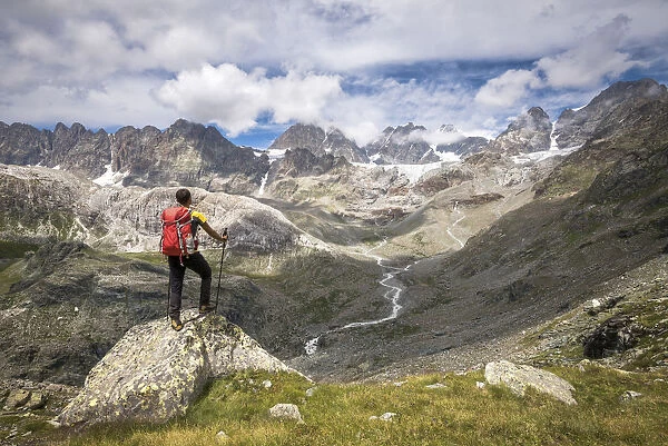 Hiker looking the peaks of the Bernina Group, Valmalenco, Province of Sondrio, Valtellina