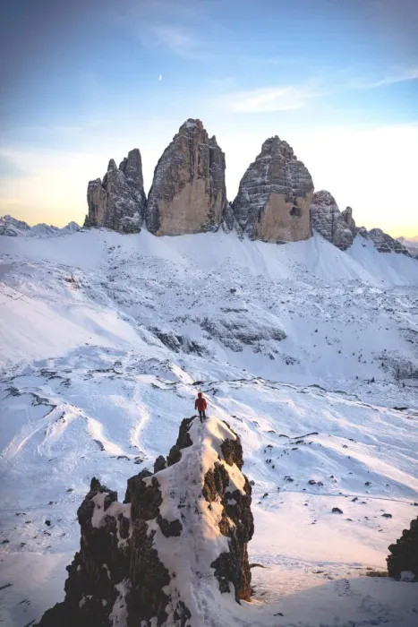 Framed Print : Hiker man on rocks admiring sunset over Tre Cime di Lavaredo surrounded by snow Framed Print : Hiker man on rocks admiring sunset over Tre Cime di Lavaredo surrounded by snow