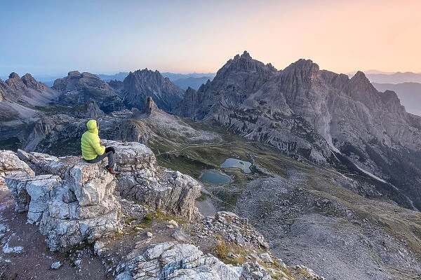 Hiker on the top of mount Paterno  /  Paternkofel looking the sunrise, Sexten Dolomites