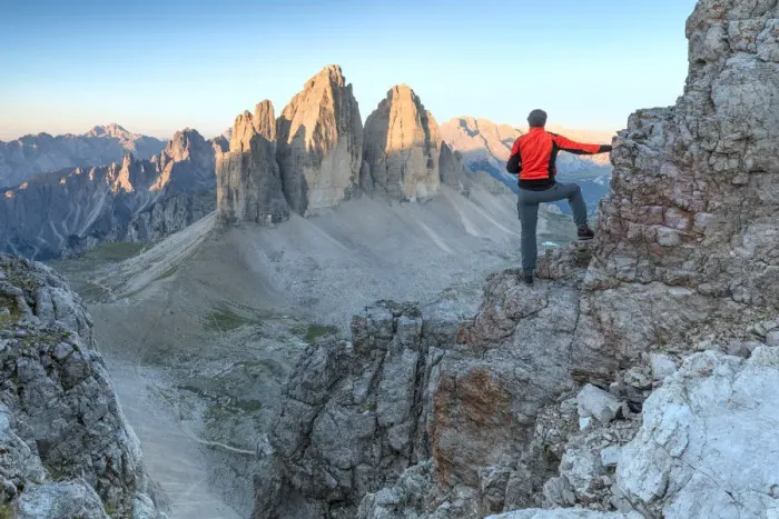 Framed Print : Hiker on the top of mount Paterno  /  Paternkofel looking the sunrise towards Tre Cime