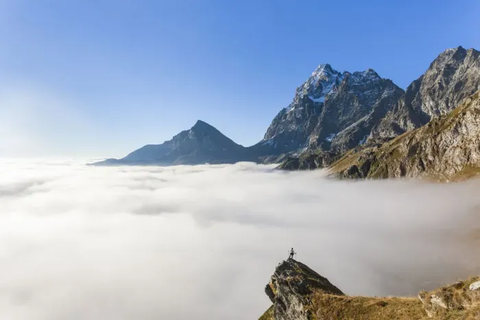 Framed Print : Hiker on top of rocks admiring Monviso emerging from fog, Crissolo, Po Valley Framed Print : Hiker on top of rocks admiring Monviso emerging from fog, Crissolo, Po Valley