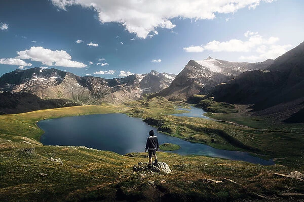 Hiker at Rosset Lake. Gran Paradiso national park, Alpi Graie, Piedmont, Italy