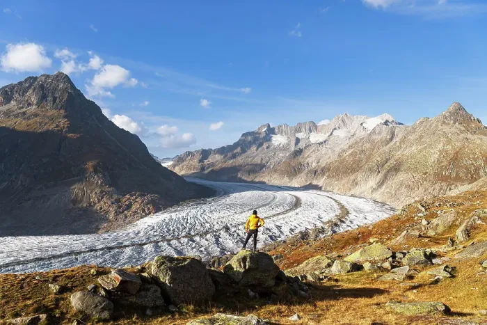 Framed Print : A hiker standing on top of a rock looking at the view of the Aletsch glacier, Bernese Alps, Valais canton, Switzerland (MR) Framed Print : A hiker standing on top of a rock looking at the view of the Aletsch glacier, Bernese Alps, Valais canton, Switzerland (MR)