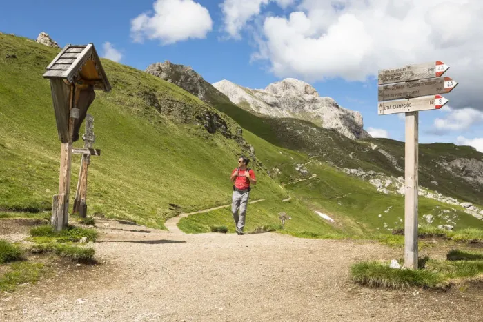 Framed Print : A hiker during a trekking at Kreuzkofeljoch in Gadertal with Peitlerkofelgruppe in Framed Print : A hiker during a trekking at Kreuzkofeljoch in Gadertal with Peitlerkofelgruppe in