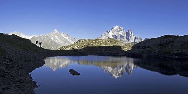 Hikers admire the view of Mont Blanc range from Lac de Chesery