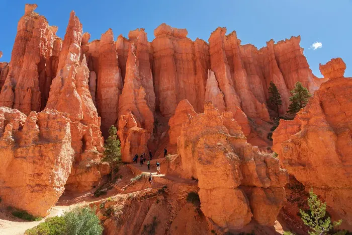 Framed Print : Hikers walking on a trail among hoodoos on Queens Garden Trail inside Bryce Canyon, Bryce Canyon National Park, Utah, USA Framed Print : Hikers walking on a trail among hoodoos on Queens Garden Trail inside Bryce Canyon, Bryce Canyon National Park, Utah, USA
