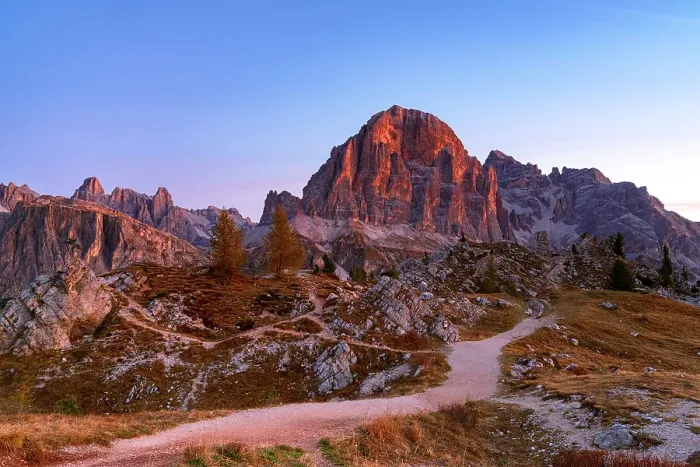 Framed Print : Empty hiking path towards the majestic Tofana di Rozes mountain at dawn in autumn, Ampezzo Dolomites, Belluno, Veneto, Italy Framed Print : Empty hiking path towards the majestic Tofana di Rozes mountain at dawn in autumn, Ampezzo Dolomites, Belluno, Veneto, Italy