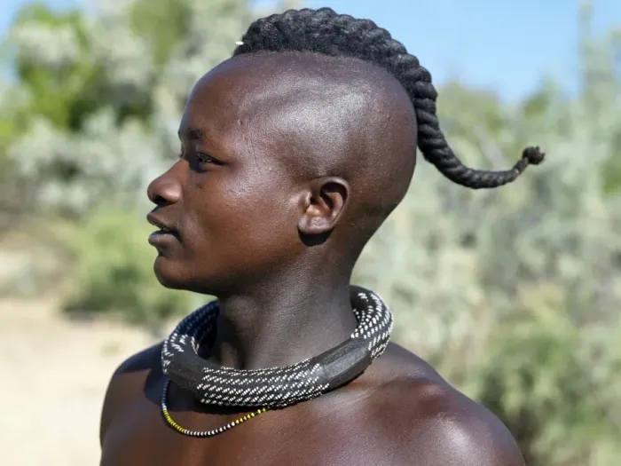 Framed Print : A Himba youth with his hair styled in a long plait, known as ondatu Framed Print : A Himba youth with his hair styled in a long plait, known as ondatu
