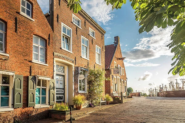 Historic brick houses at the harbor in Greetsiel, East Frisia, Lower Saxony, Germany