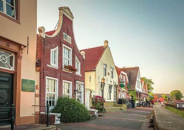 Historic brick houses at the harbor in Greetsiel, East Frisia, Lower Saxony, Germany