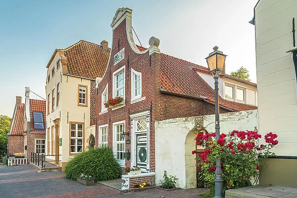 Historic houses at the harbor in Greetsiel, East Frisia, Lower Saxony, Germany