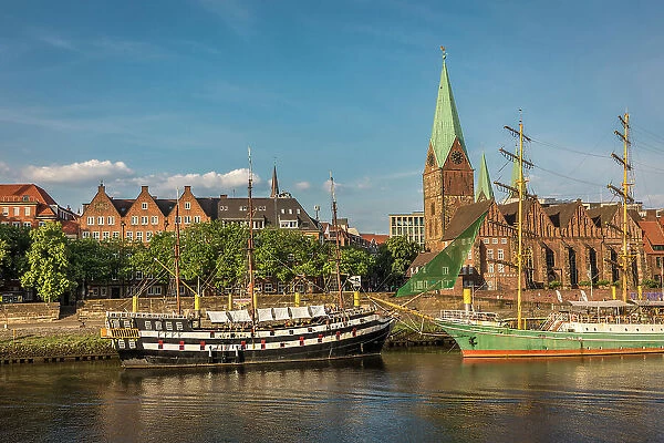 Historic sailing ships Admiral Nelson and Alexander von Humboldt at the Martini pier with St. Martini Church, Bremen, Germany