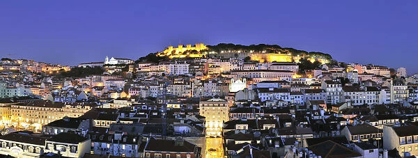 The historical centre and the Sao Jorge castle at dusk. Lisbon, Portugal
