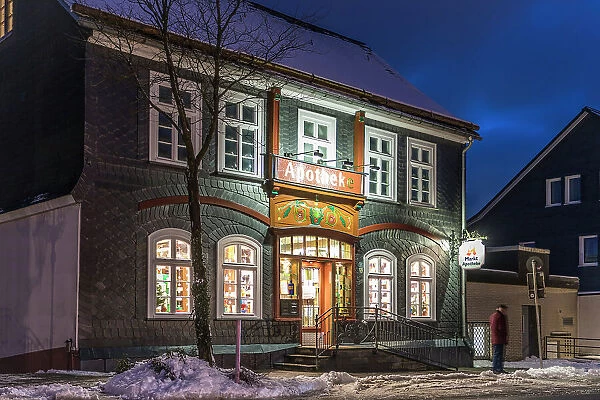 Historical pharmacy in the old town of Winterberg on a winter evening, Sauerland, North Rhine-Westphalia, Germany