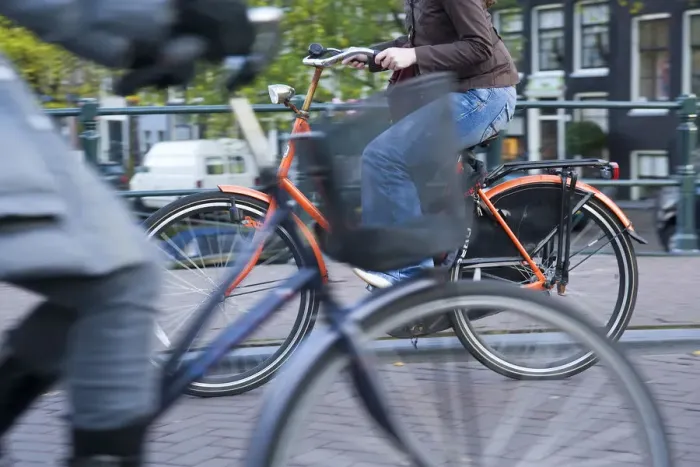 Framed Print : Holland, Amsterdam, riding a bicycle over a canal bridge