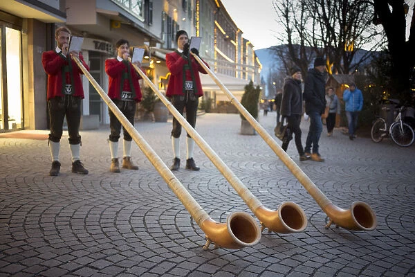 three horn players during the Christmas market in a strret of the city of Bruneck