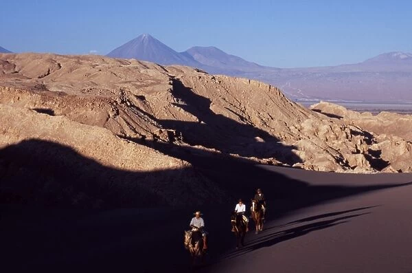 Horse riding amongst the wind-eroded peaks and lunar