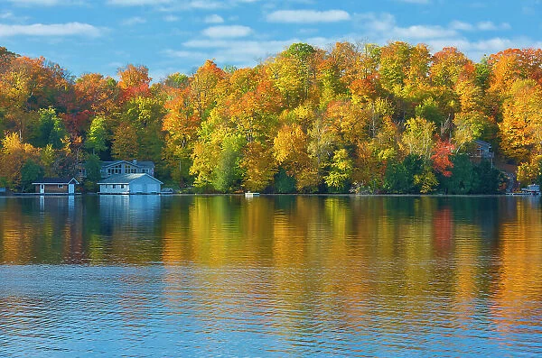 Horseshoe Lake in autumn with cottage, Near Parry Sound, Ontario, Canada