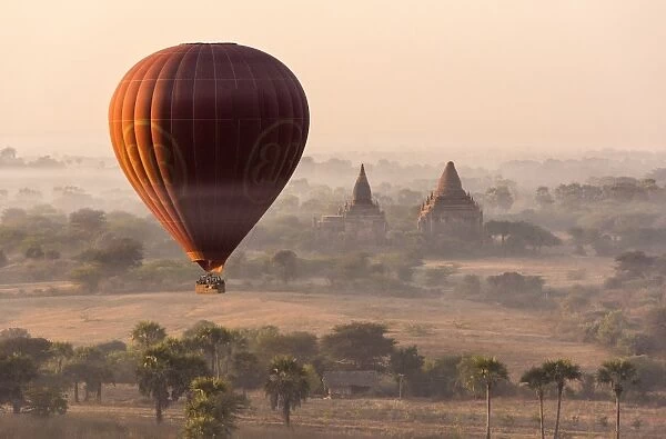 A hot-air balloon flying over pagodas in Bagan, Myanmar
