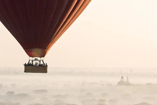 Hot air balloon flying over pagodas in Bagan, Myanmar