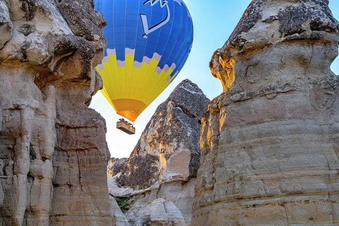 Framed Print : Hot air balloon flying between rock formations, Love Valley, Goreme National Park, Cappadocia, Central Anatolia, Turkey Framed Print : Hot air balloon flying between rock formations, Love Valley, Goreme National Park, Cappadocia, Central Anatolia, Turkey