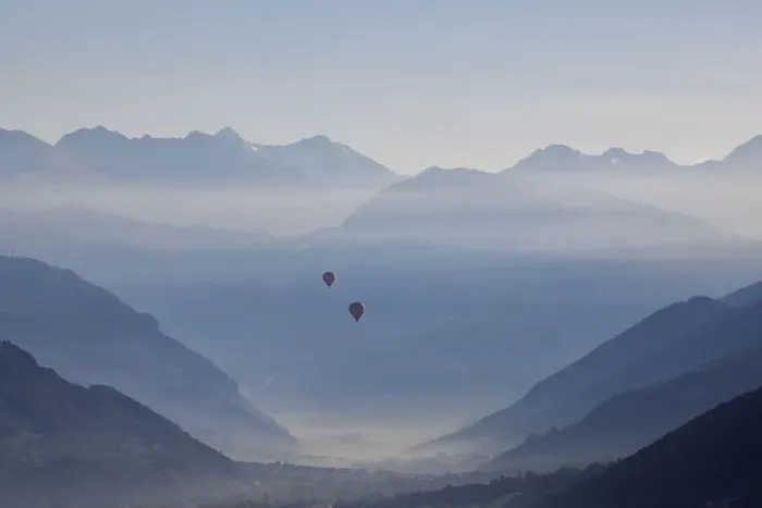 Framed Print : Two hot air balloons fly over the city of Aosta, Aosta province Framed Print : Two hot air balloons fly over the city of Aosta, Aosta province