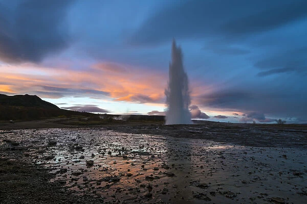 Hot spring splashing at Strokkur during sunset, Geysir, South Iceland, Iceland