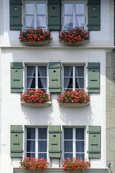 Front of a house with flowerboxes in Bern, Switzerland