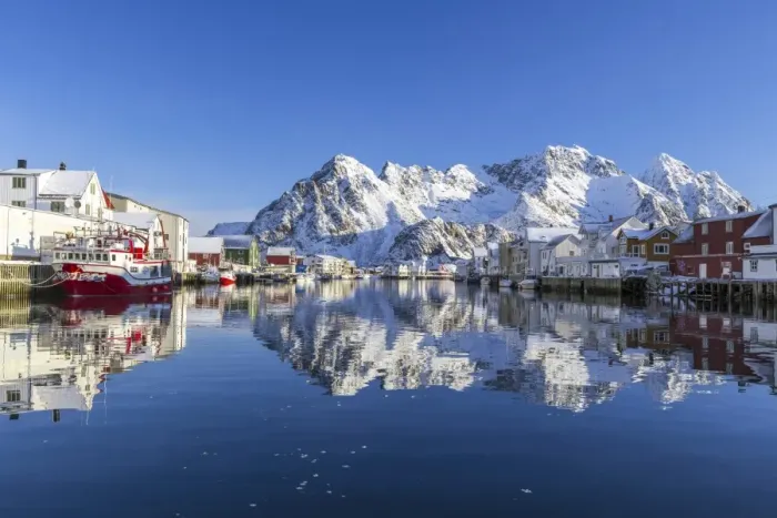 Framed Print : Houses and mountains reflected in the waters of Henningsvaer fjord. Lofoten Islands