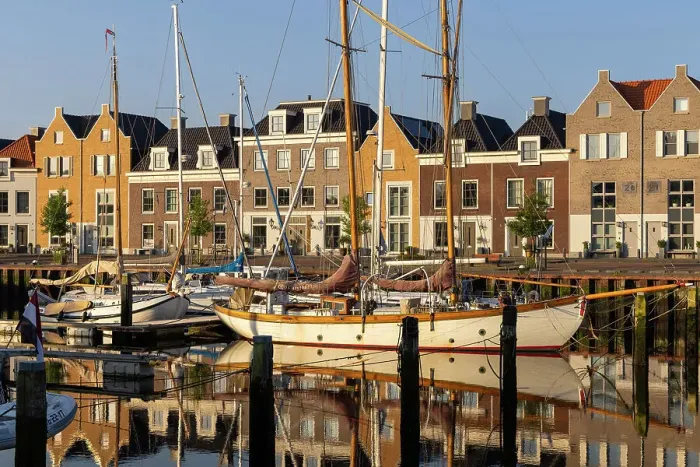 Framed Print : Houses along the old port reflected in the calm water, Harlingen, Friesland, Netherlands