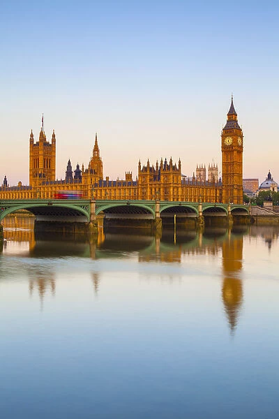 The Houses of Parliament & The River Thames illuminated at sunrise