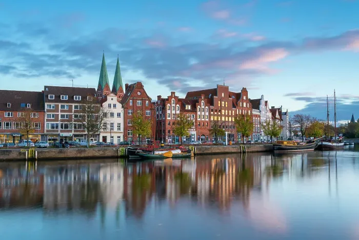 Framed Print : Houses on riverfront of Trave river with towers of St. Marienkirche church in background at sunset, Lubeck, UNESCO, Schleswig-Holstein, Germany Framed Print : Houses on riverfront of Trave river with towers of St. Marienkirche church in background at sunset, Lubeck, UNESCO, Schleswig-Holstein, Germany